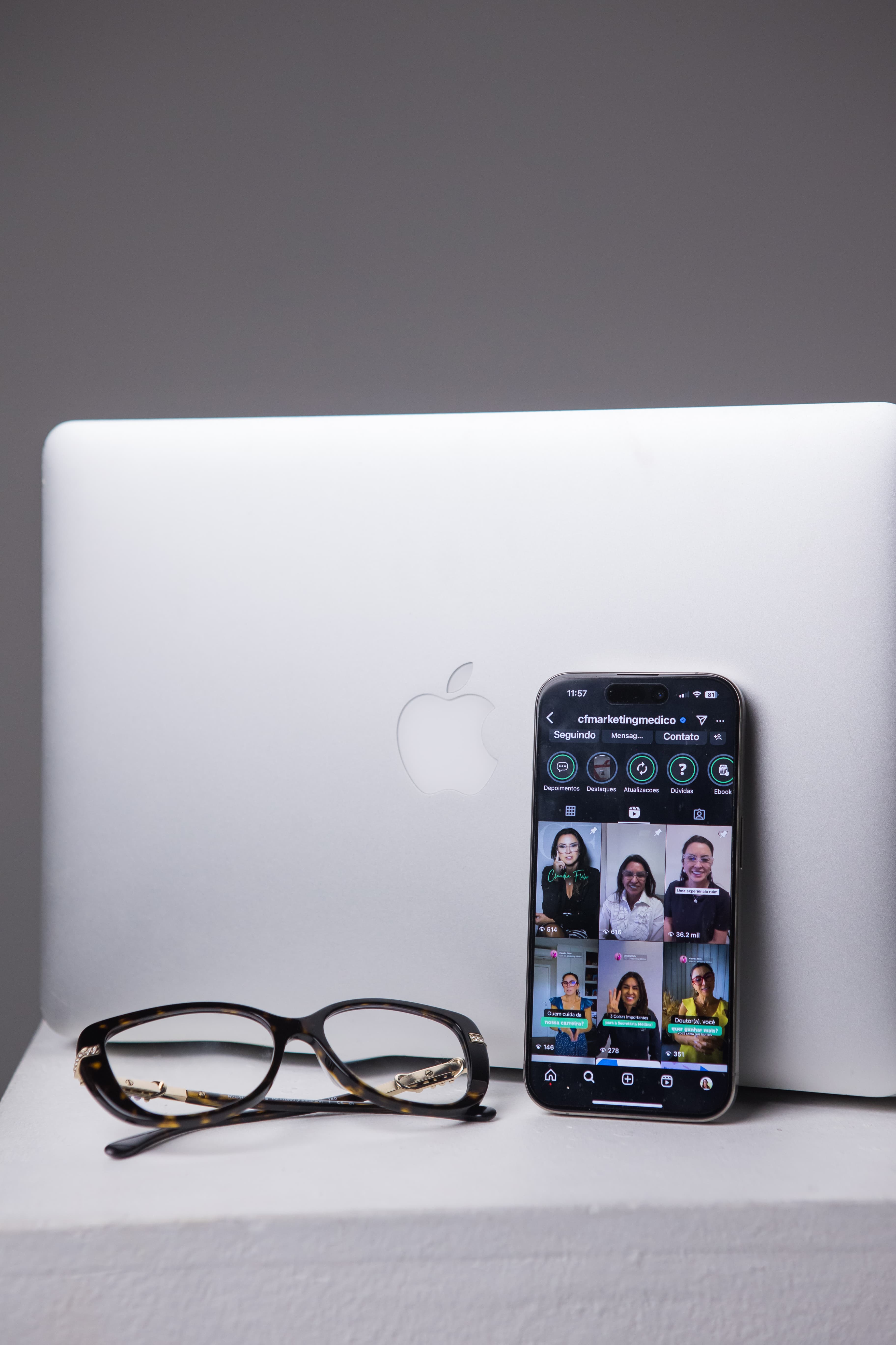 Close-up of a MacBook and iPhone showing CF's profile