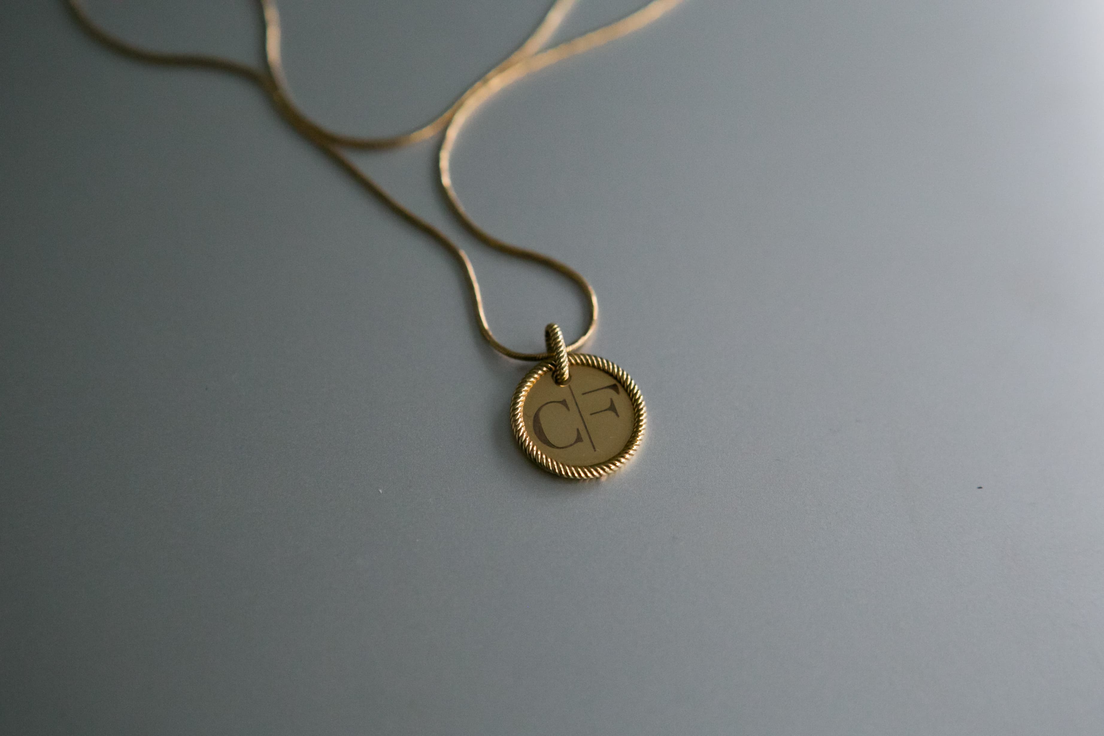 Close-up of the golden CF necklace